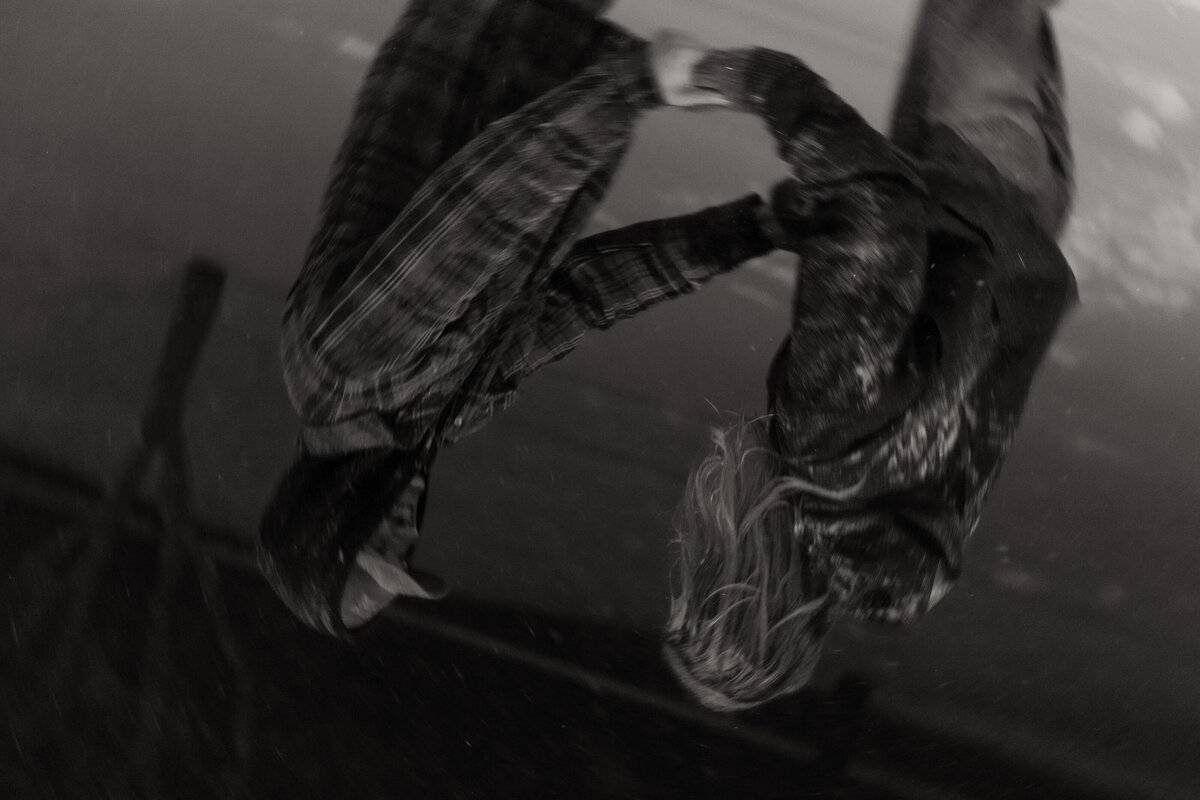 Upside down photo of couple looking at each other for their winter engagement shoot in black and white 