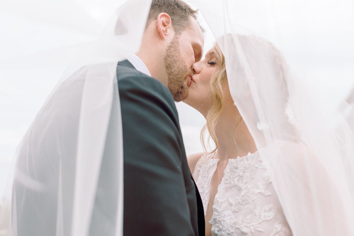 Couple cover over the veil and kissing