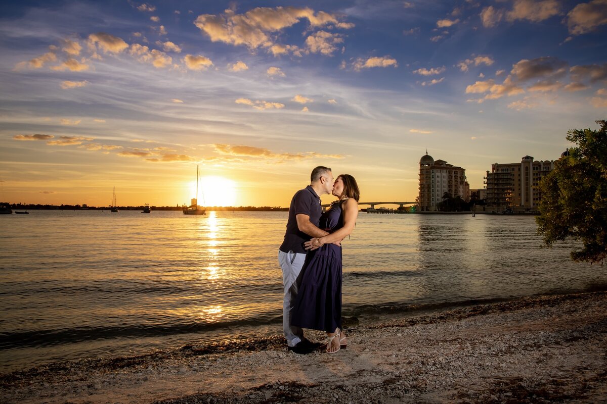 Couple kissing with romantic sunset background at Bayfront Park, Sarasota