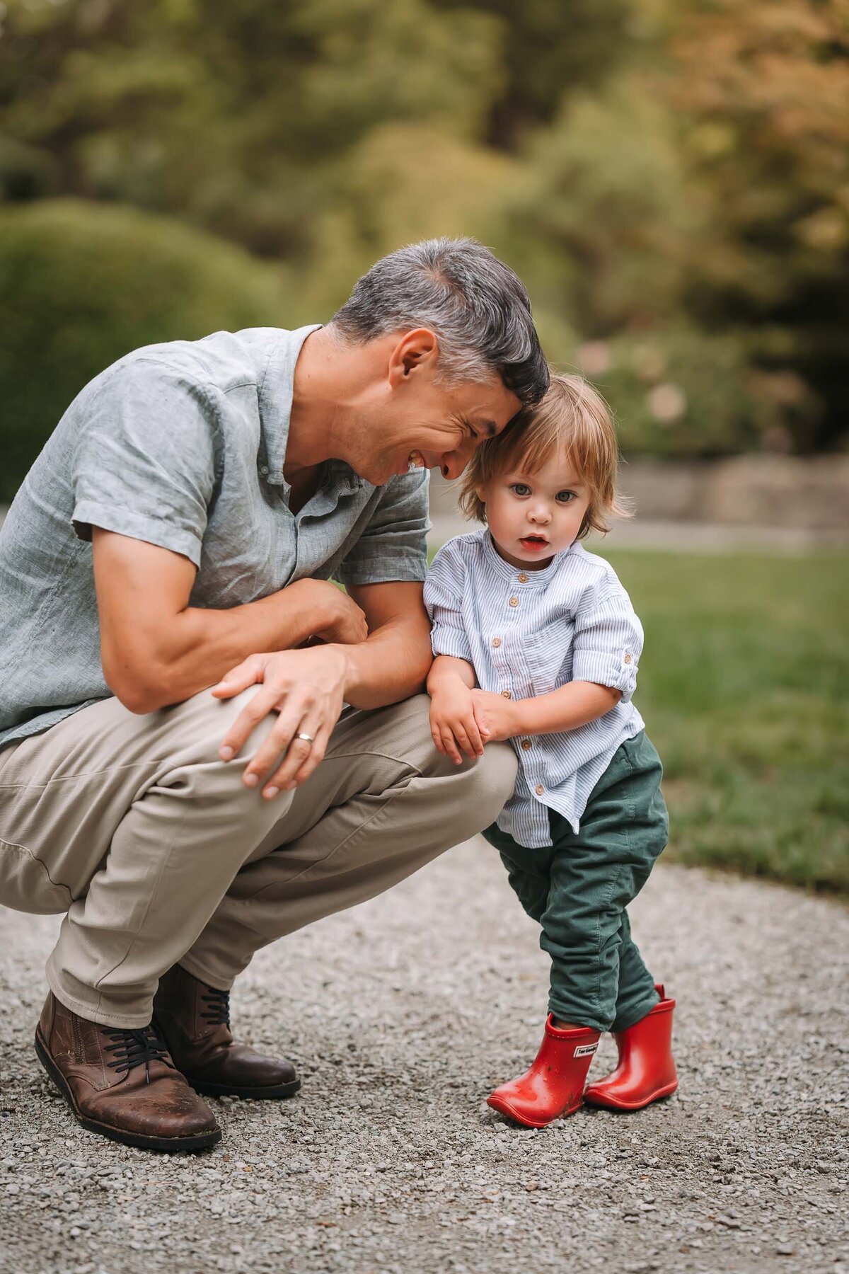 Heartwarming father and son moment, capturing a playful and loving interaction between the two during a family photo shoot.