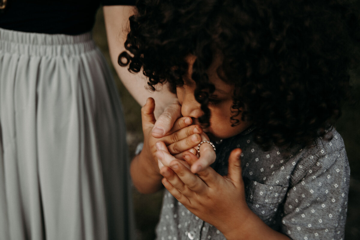 son kissing mom's hand