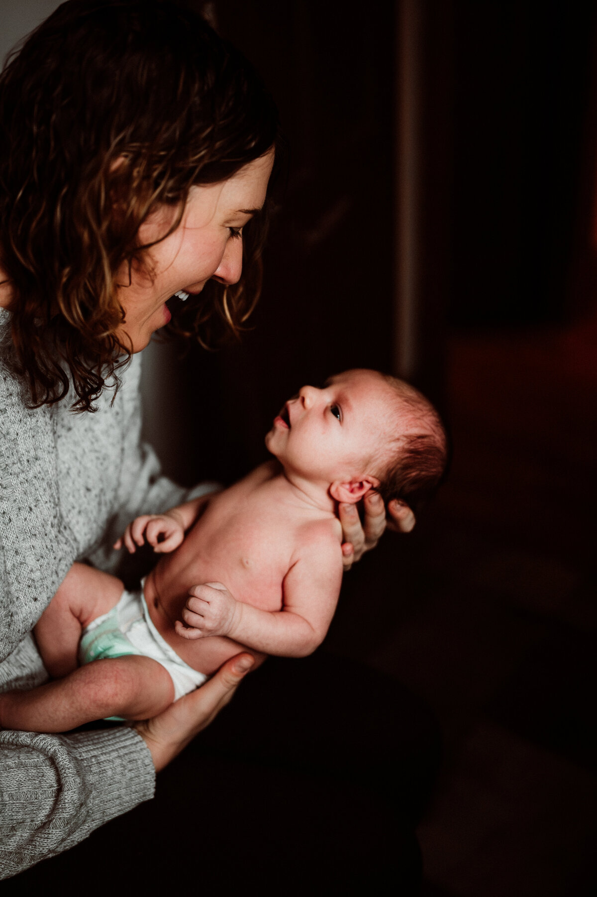 Newborn baby boy resting on a cozy blanket during a natural light newborn photography session in Minnesota