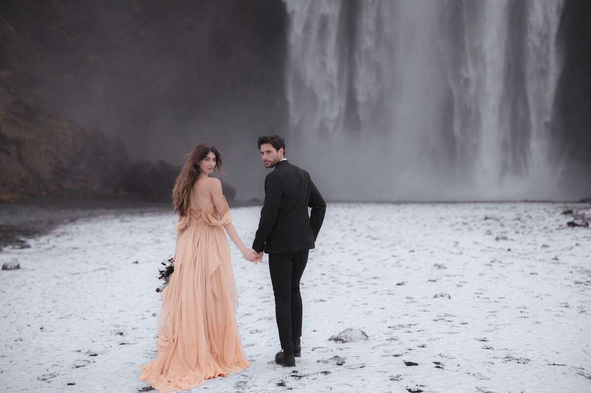Iceland waterfall elopement photo edited with Golden Serenity presets – soft cinematic tones, rich contrast, and golden warmth for adventurous destination weddings.