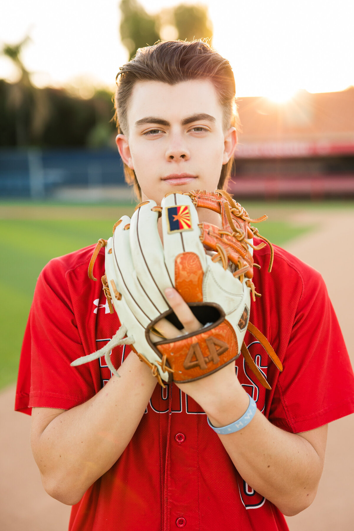 high school senior boy posing for Scottsdale senior photography session in baseball attire
