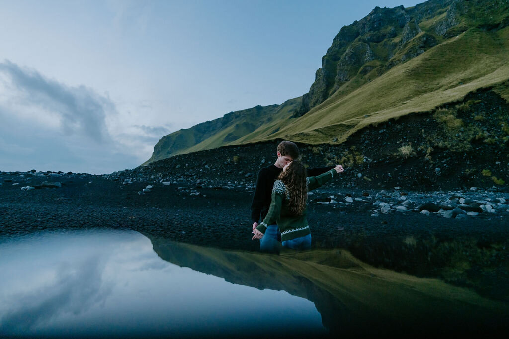 couple on black sand beach in iceland