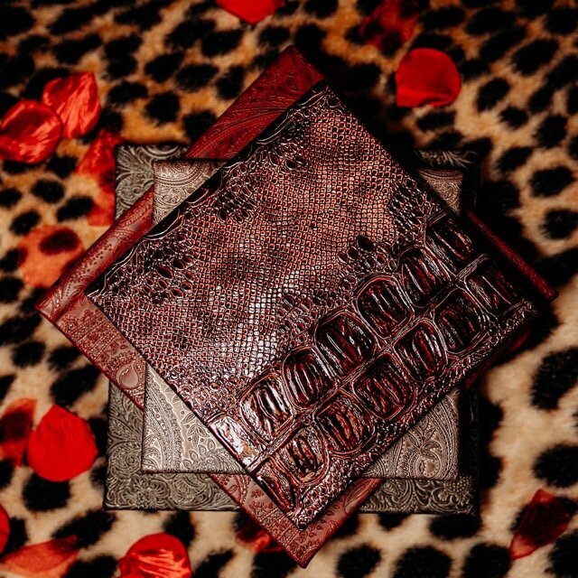 Boudoir photography four keepsake albums on leopard rug in Lubbock, Texas photographer in Amarillo TX