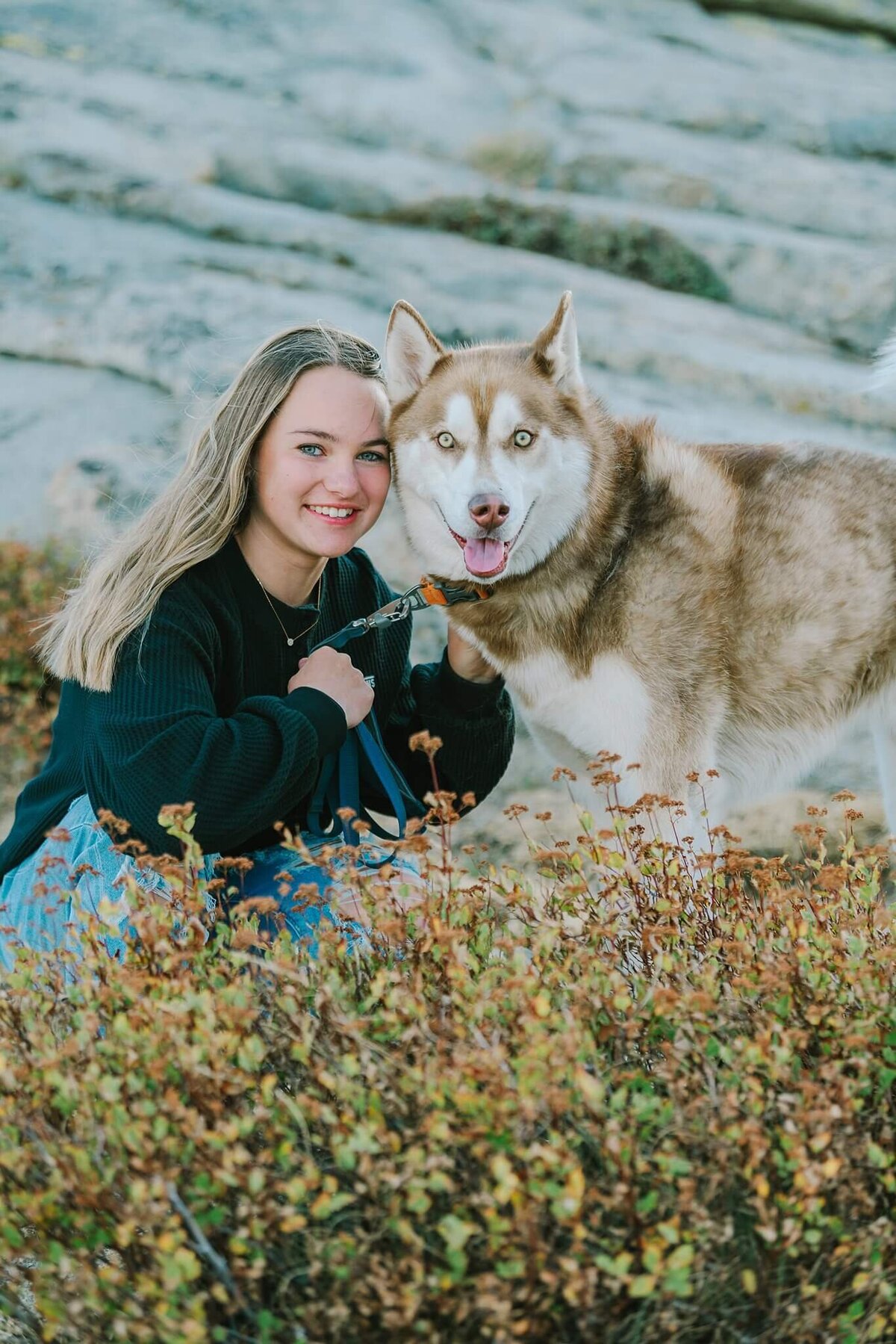 girl with her dog facing camera on Donner summit