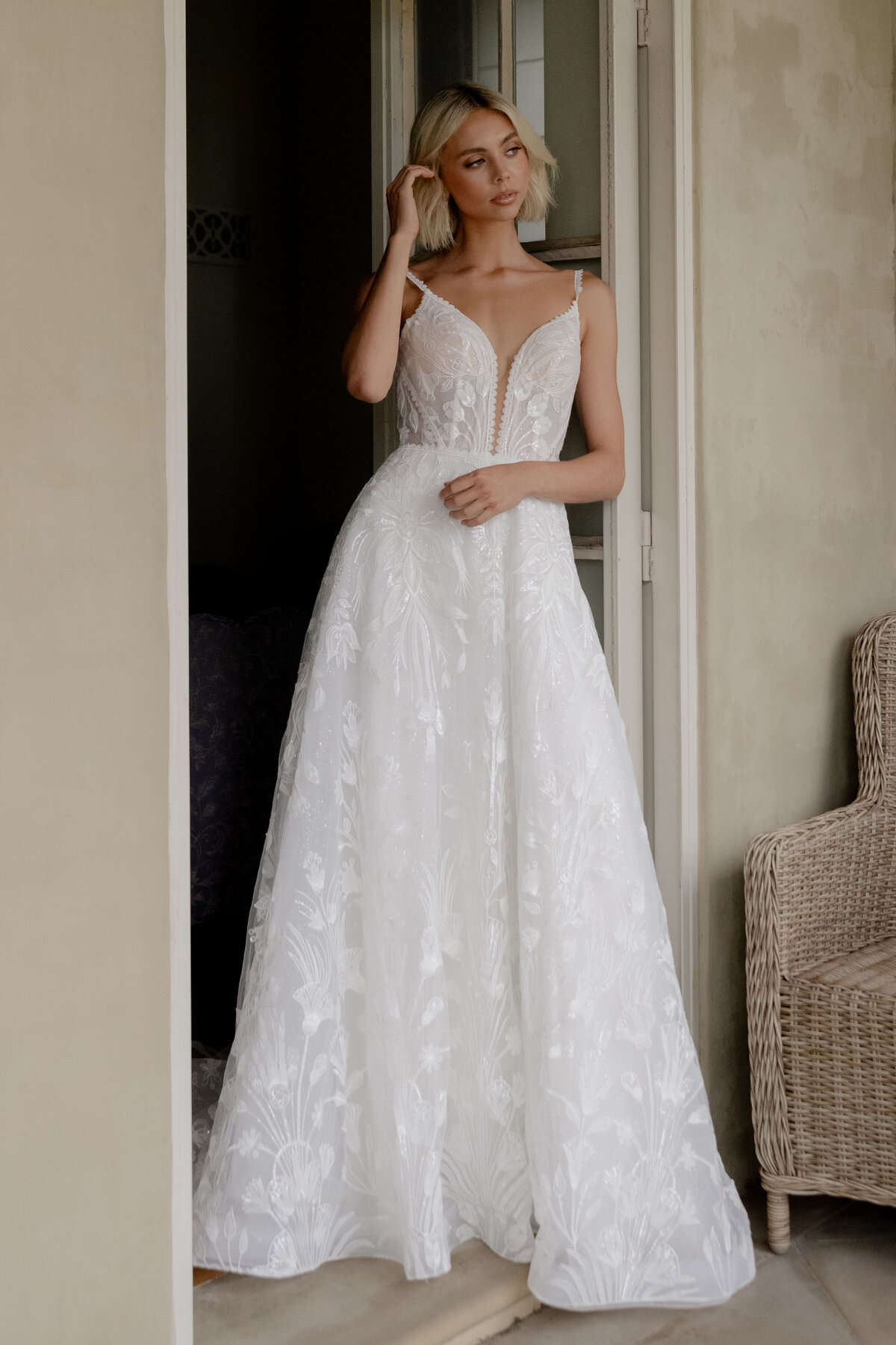 Model posing in wedding dress next to door