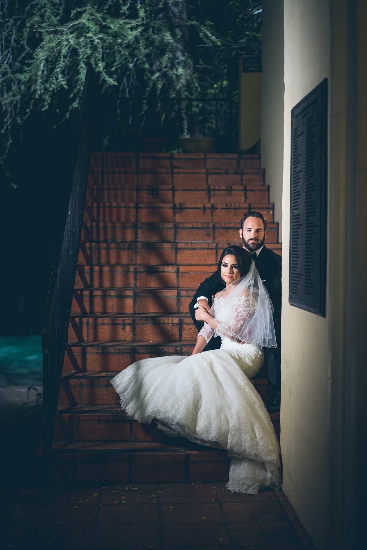 Bride and groom sitting on the steps at the Witti Museum wedding venue in downtown San Antonio