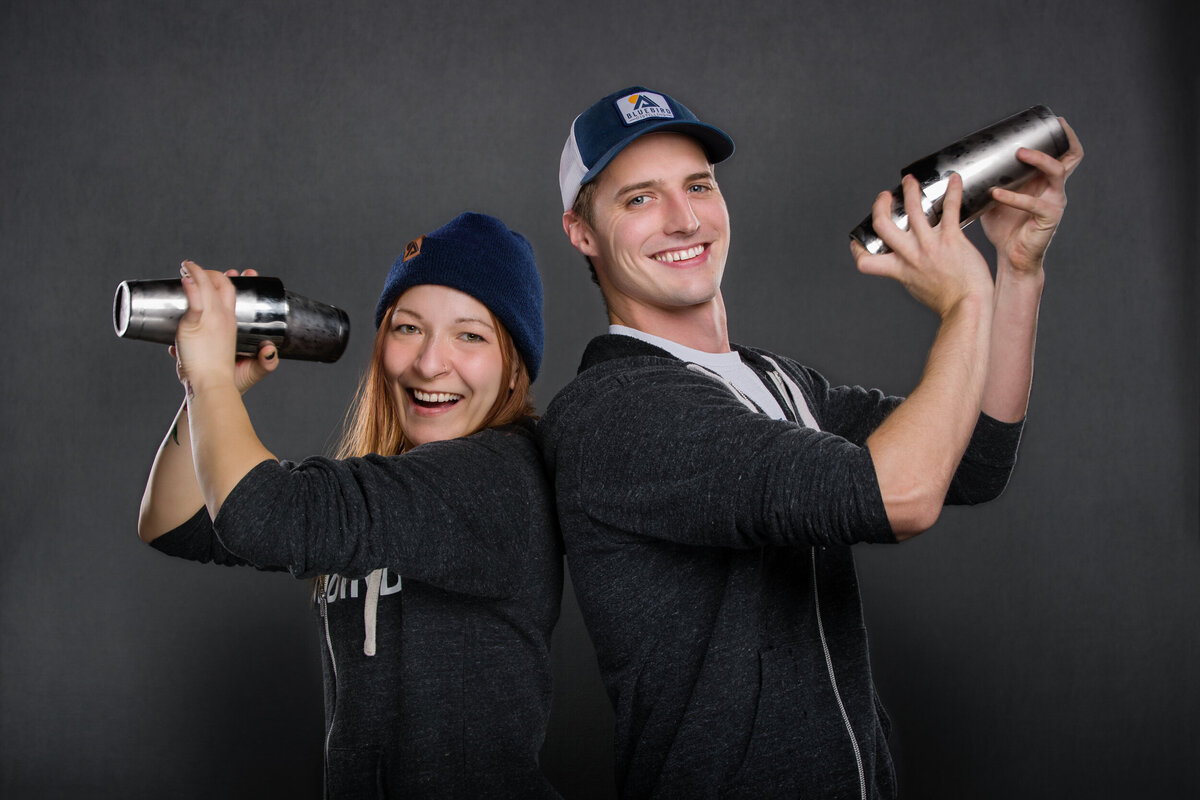 Branding photo of two bar tenders making drinks with shakers