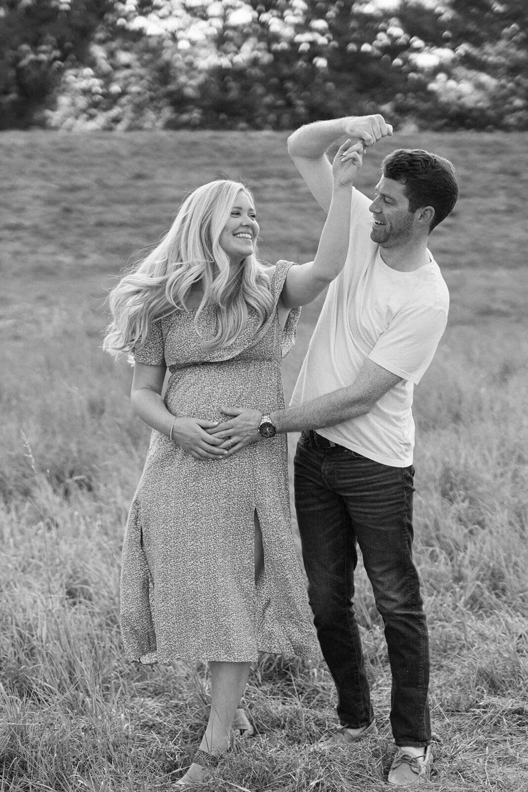 Couple dancing in a field for  maternity session in Finger Lakes, New York