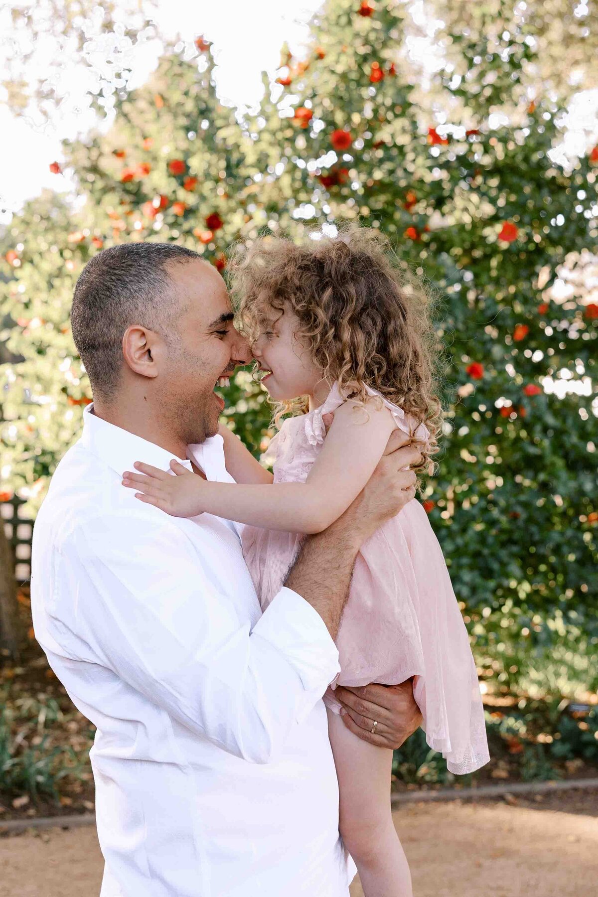 dad and daughter giving eskimo kisses