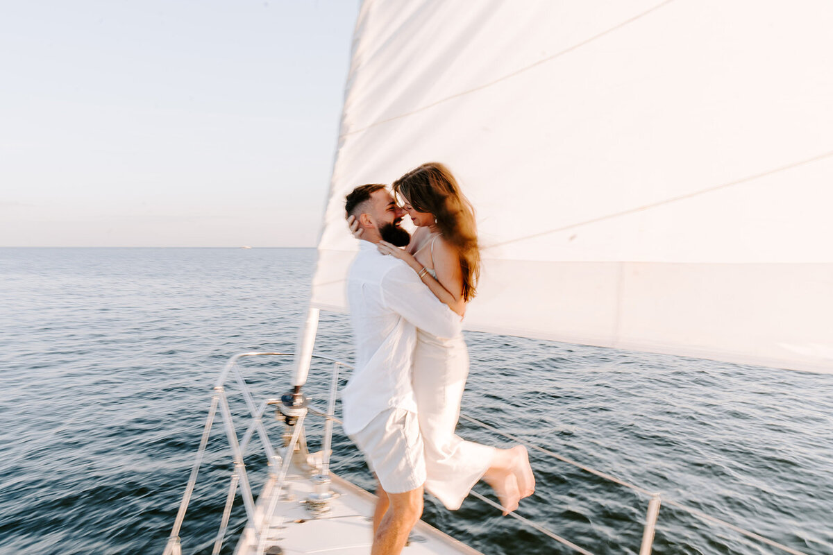 newlyweds pose silly on boardwalk