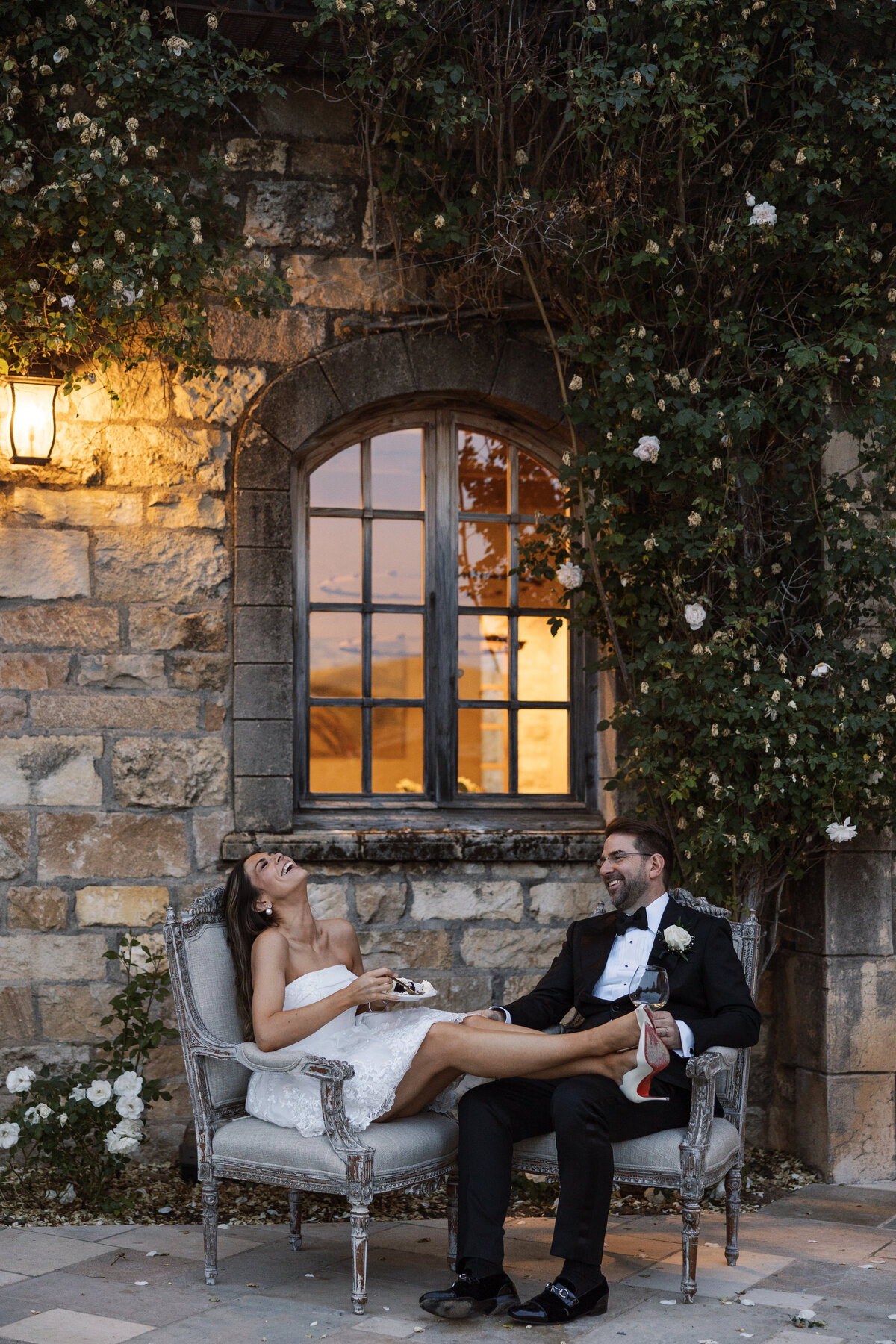 Couple laughing eating wedding cake during reception at Sunstone Villa in Santa Ynez