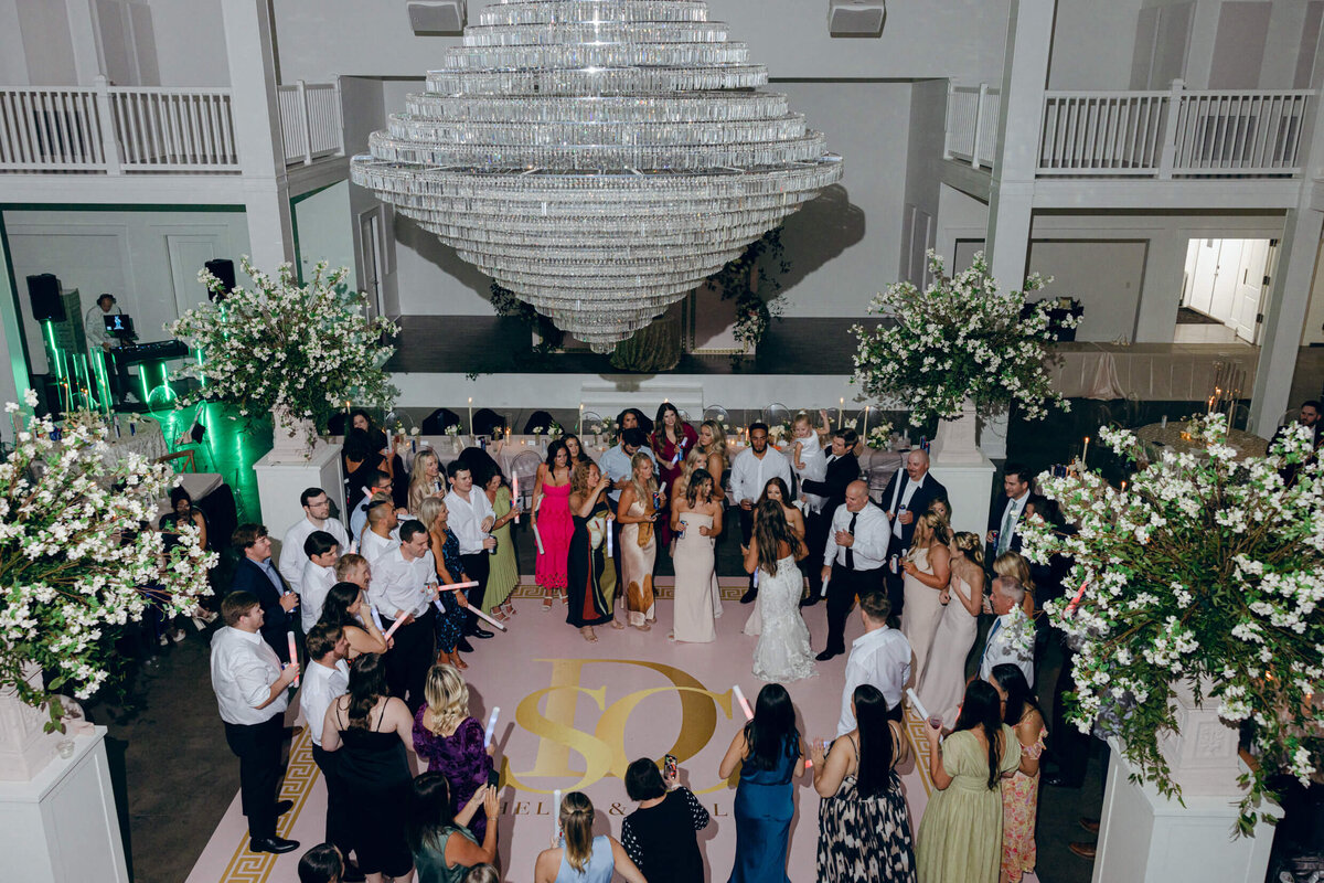 A wedding photo of guests dancing during the wedding reception