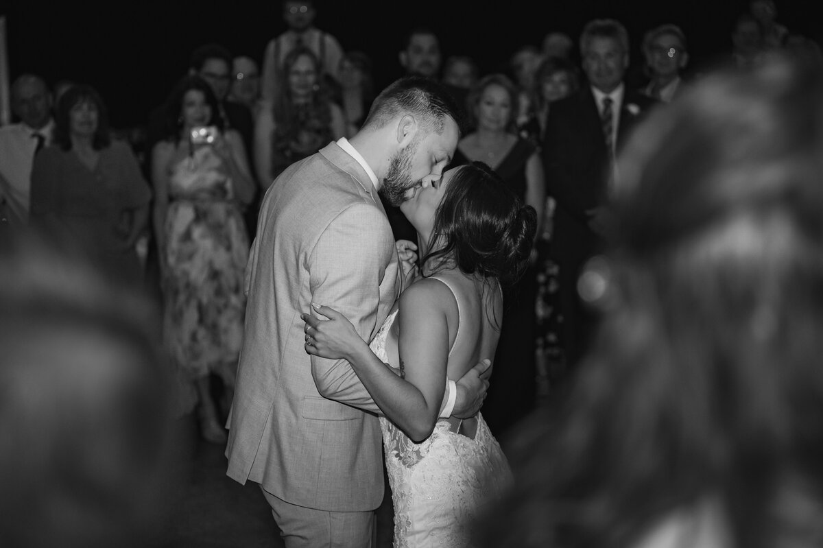 bride and groom kissing on dancefloor