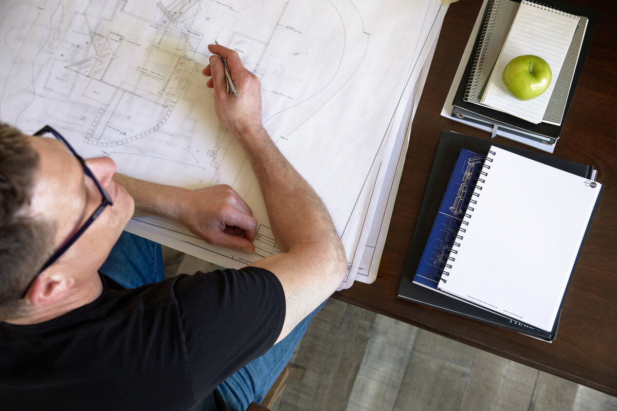 man-working-on-blueprints