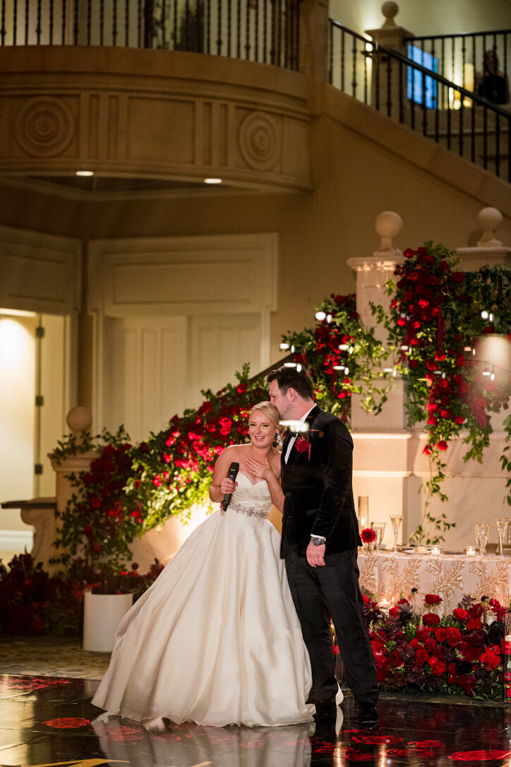 wedding speeches, southern smilax, staircase flowers, ballgown, red, black tux, pocket boutonniere, sweetheart table  