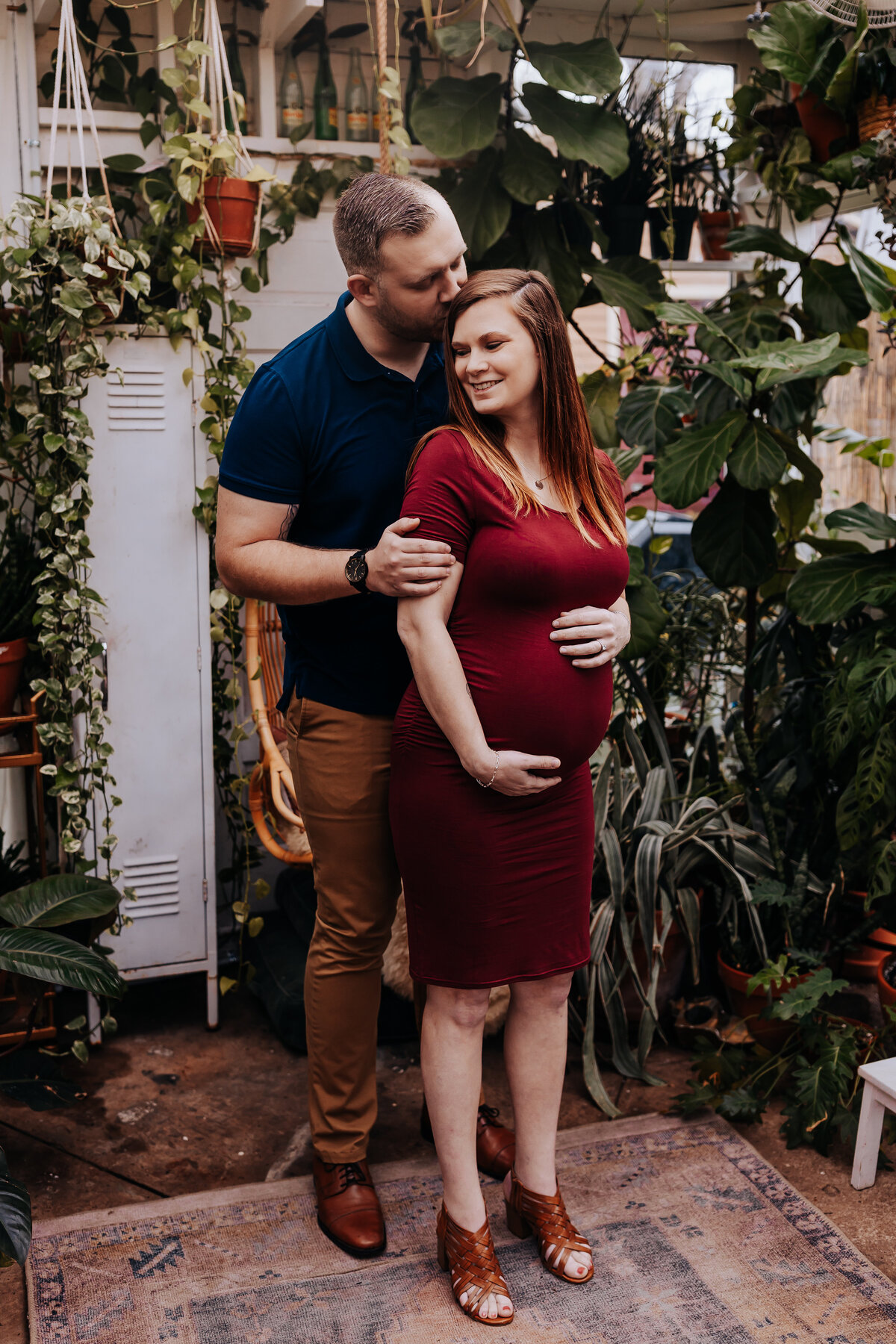 Nashville newborn photographer captures mother holding belly during maternity photos