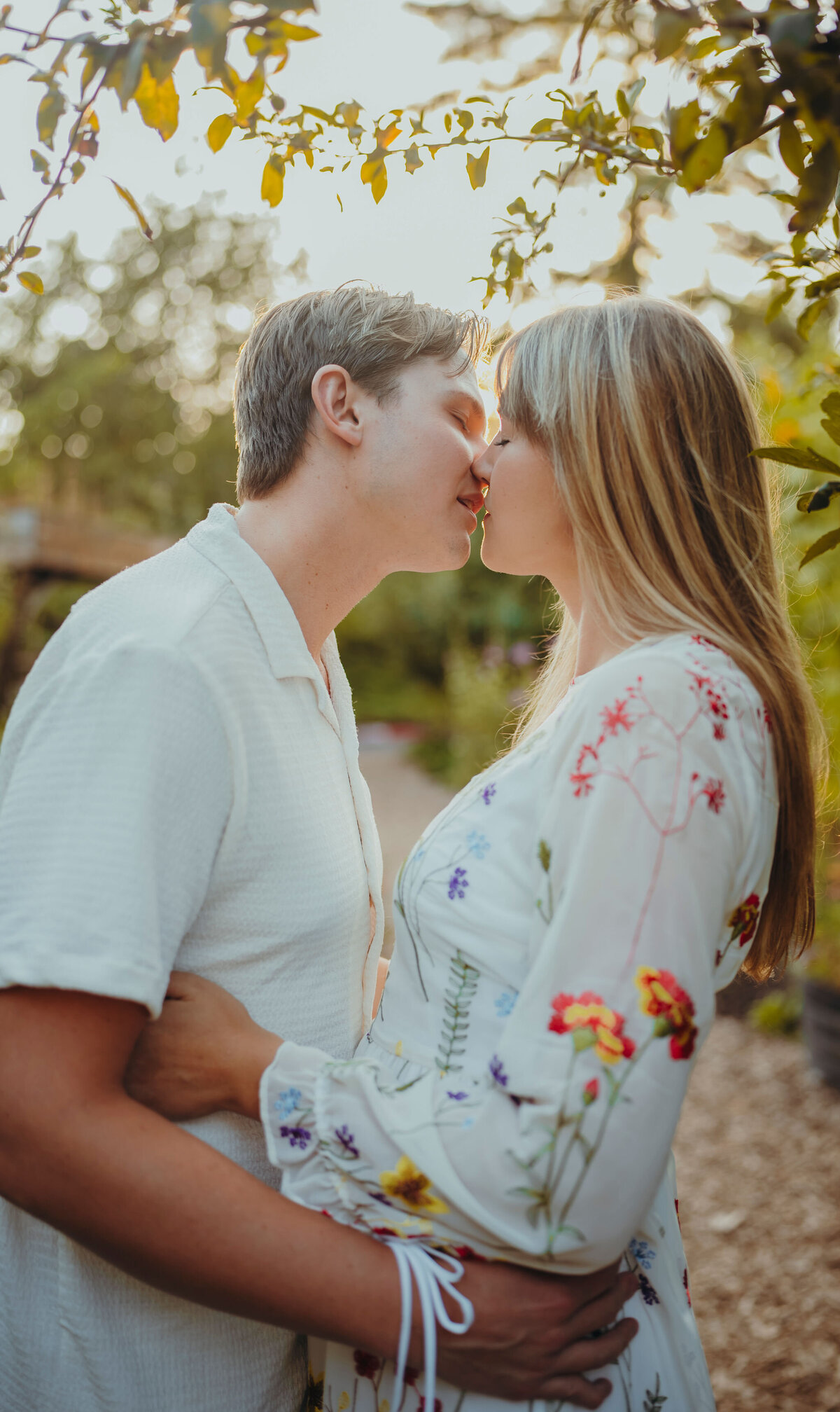 an engaged couple kissing