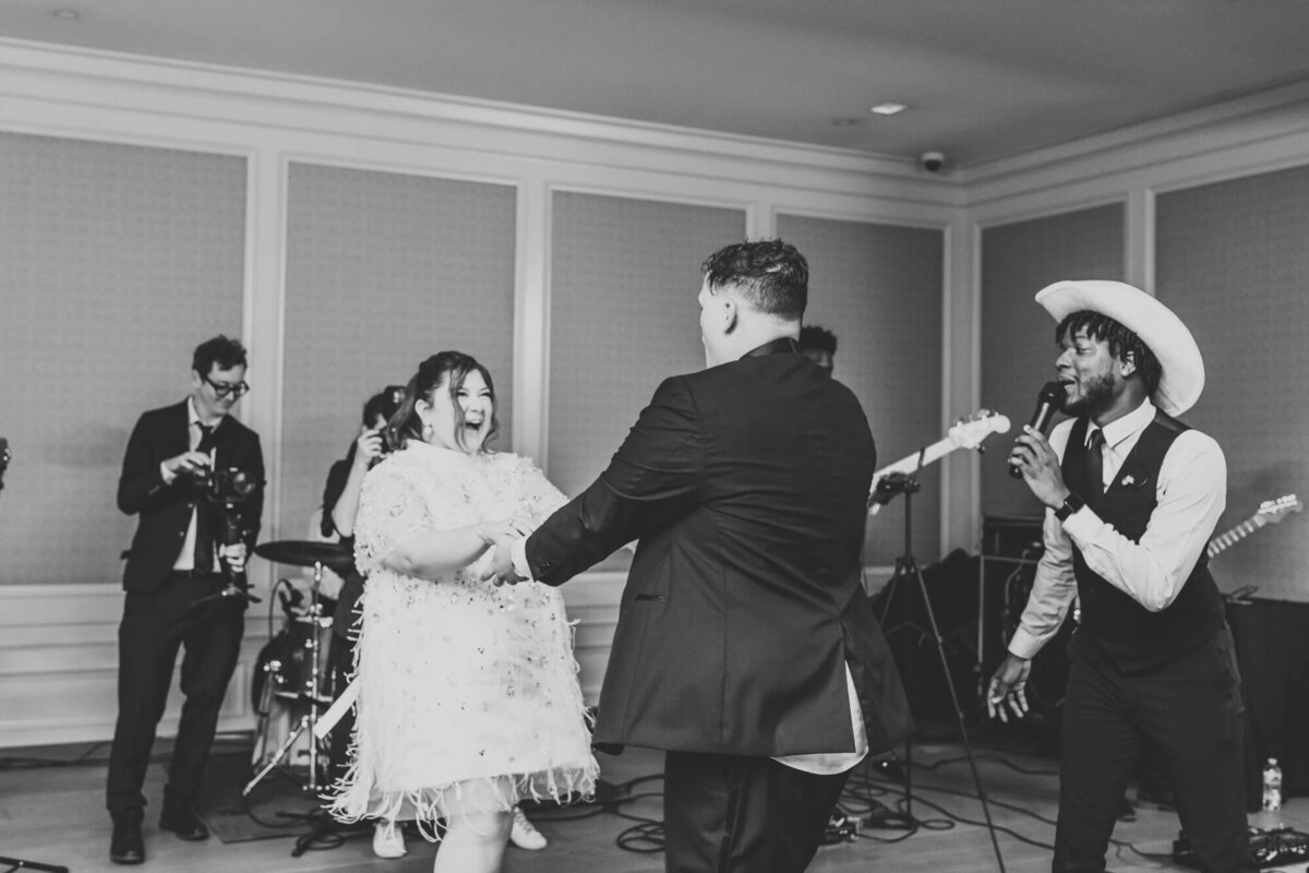 bride and groom share a fun dance on stage.