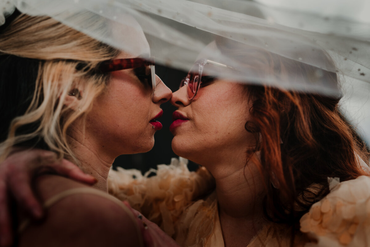 Creative photography of two brides under a veil