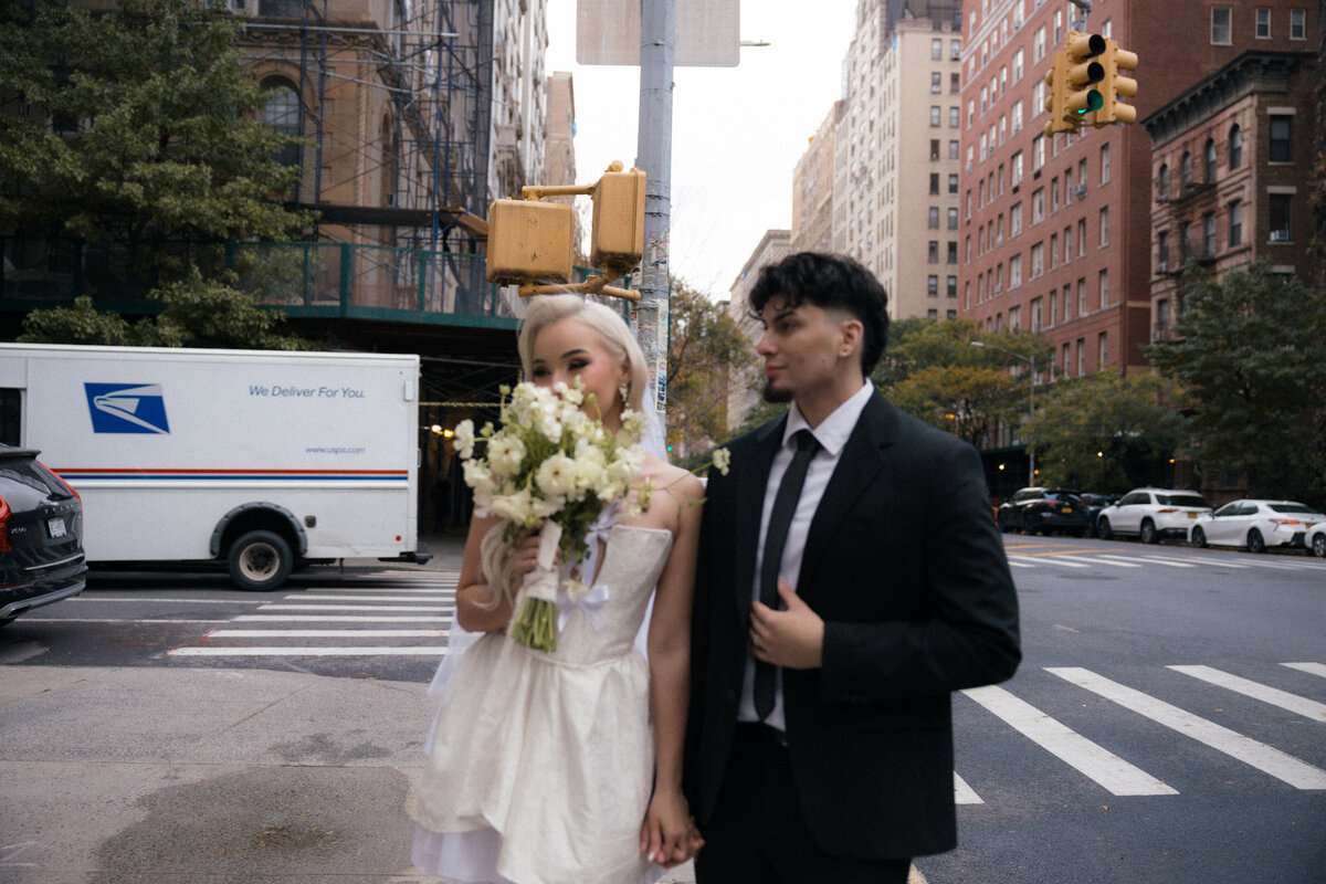 Couple walking hand-in-hand down a quiet NYC street during their elopement.