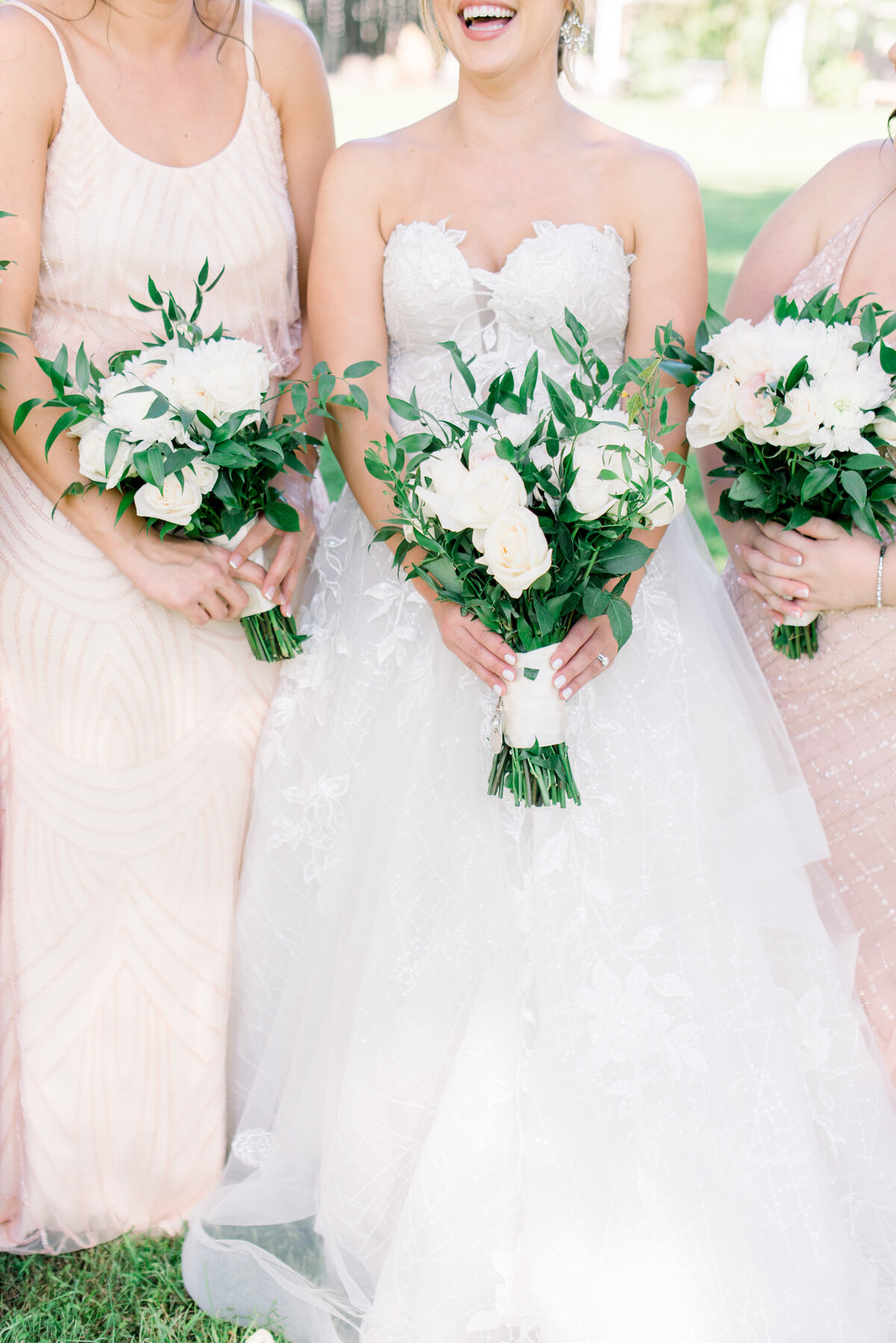 Bride and bridesmaids holding bouquets.