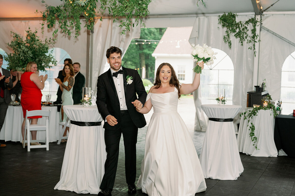 Bride and groom dancing together during their Morris Estate reception surrounded by guests.