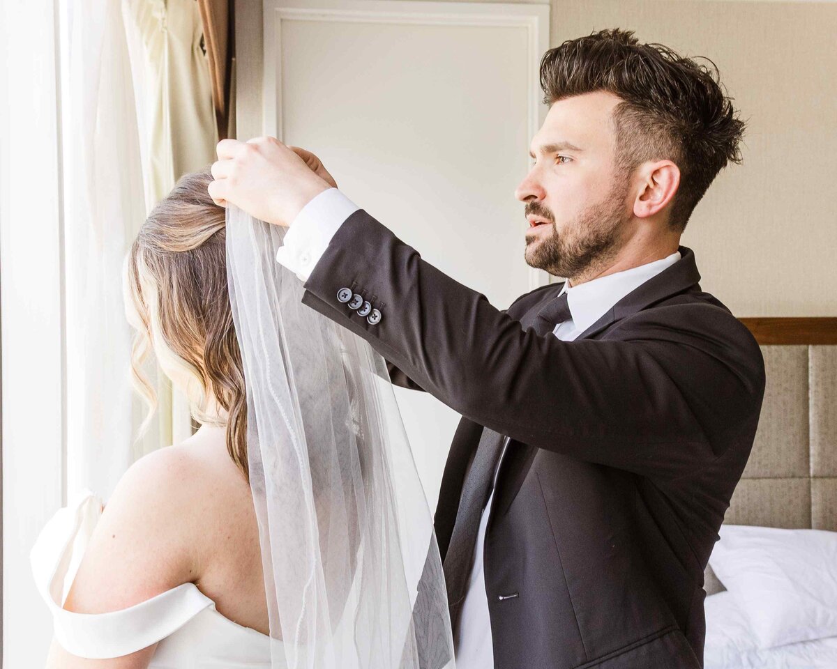 13-groom-adjusting-brides-veil