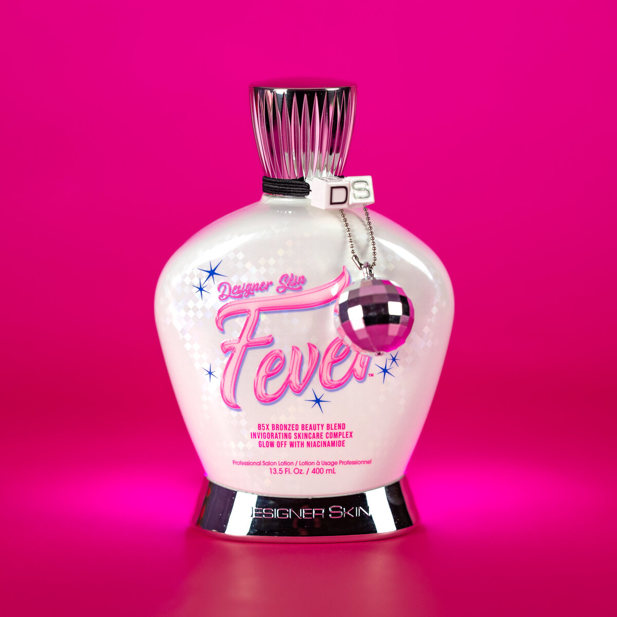 A perfume bottle against a pink backdrop