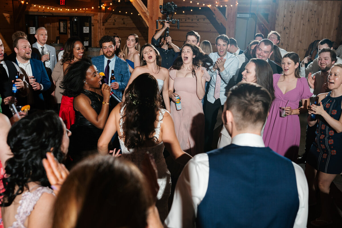 Elegant reception setup with candles, florals, and wooden tables