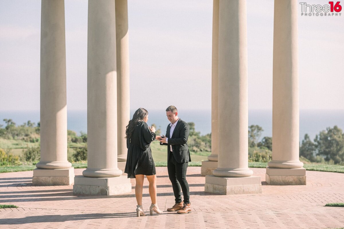 Newly engaged couple admire her new engagement ring during their Pelican Hill Resort engagement session.