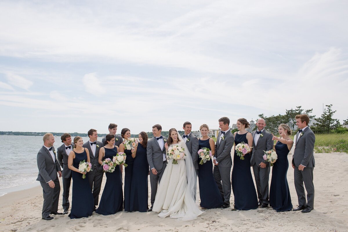 Wedding party celebrate on the beach during Cape Cod wedding