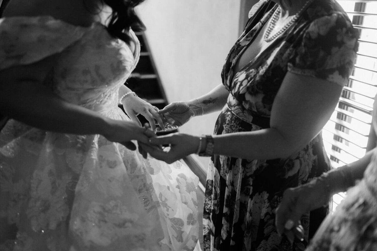 bride-and-mom-holding-hands