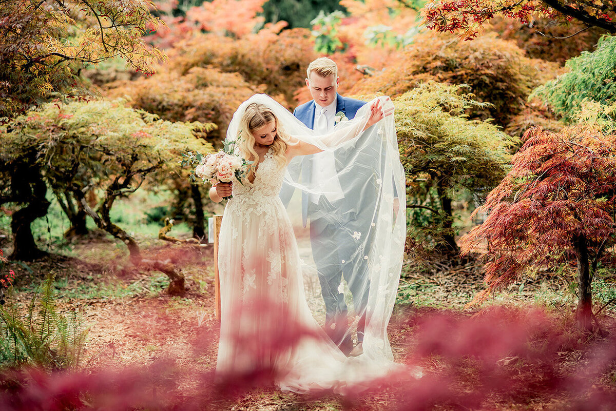 groom and bride in fall leaves