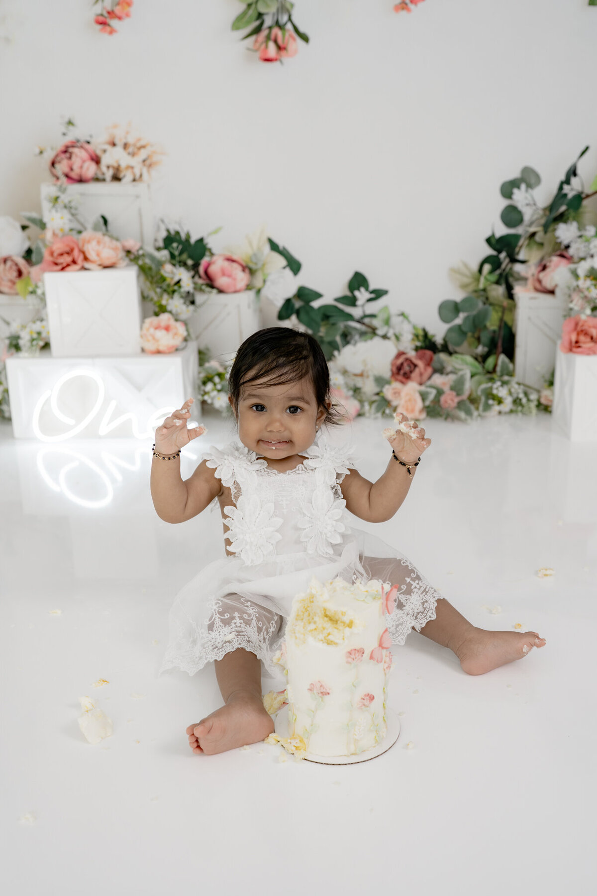 Girl eating cake during floral themed cake smash session— captured by Alliston and Barrie cake smash photographer.