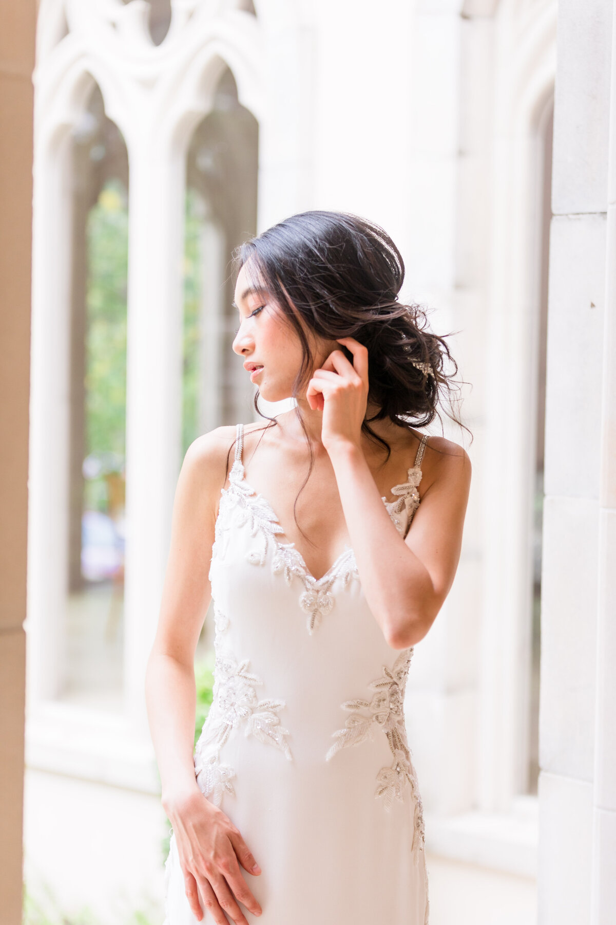 Light and Airy Bride poses in her wedding dress