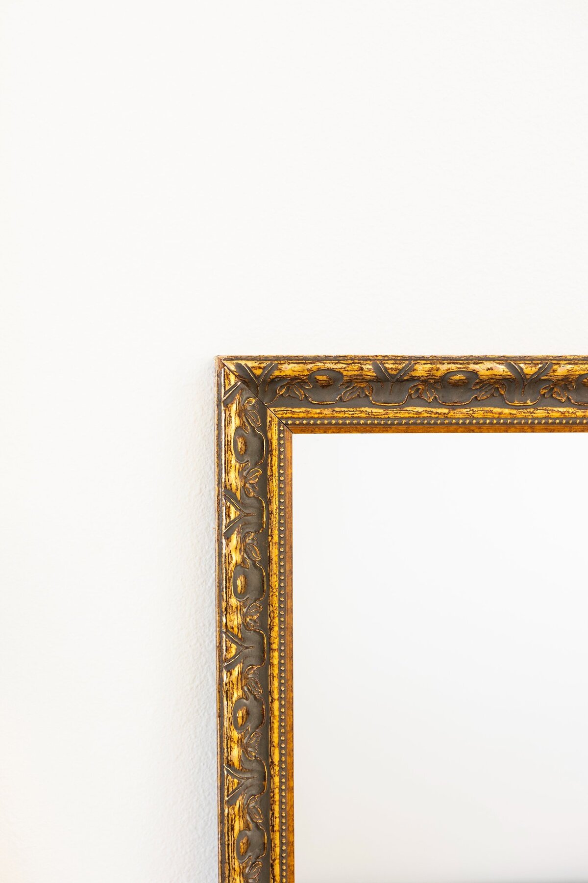 Large gold mirror with ornate border 