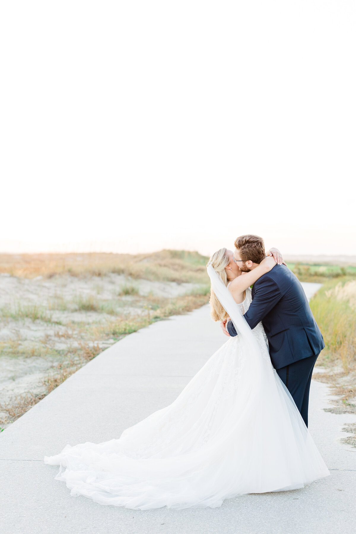 bride and groom kissing on Kiawah Island, SC