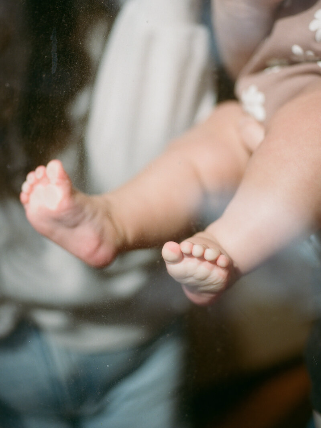 baby toes pushing against window using film photography at in-home photo session from huntsville alabama photographers