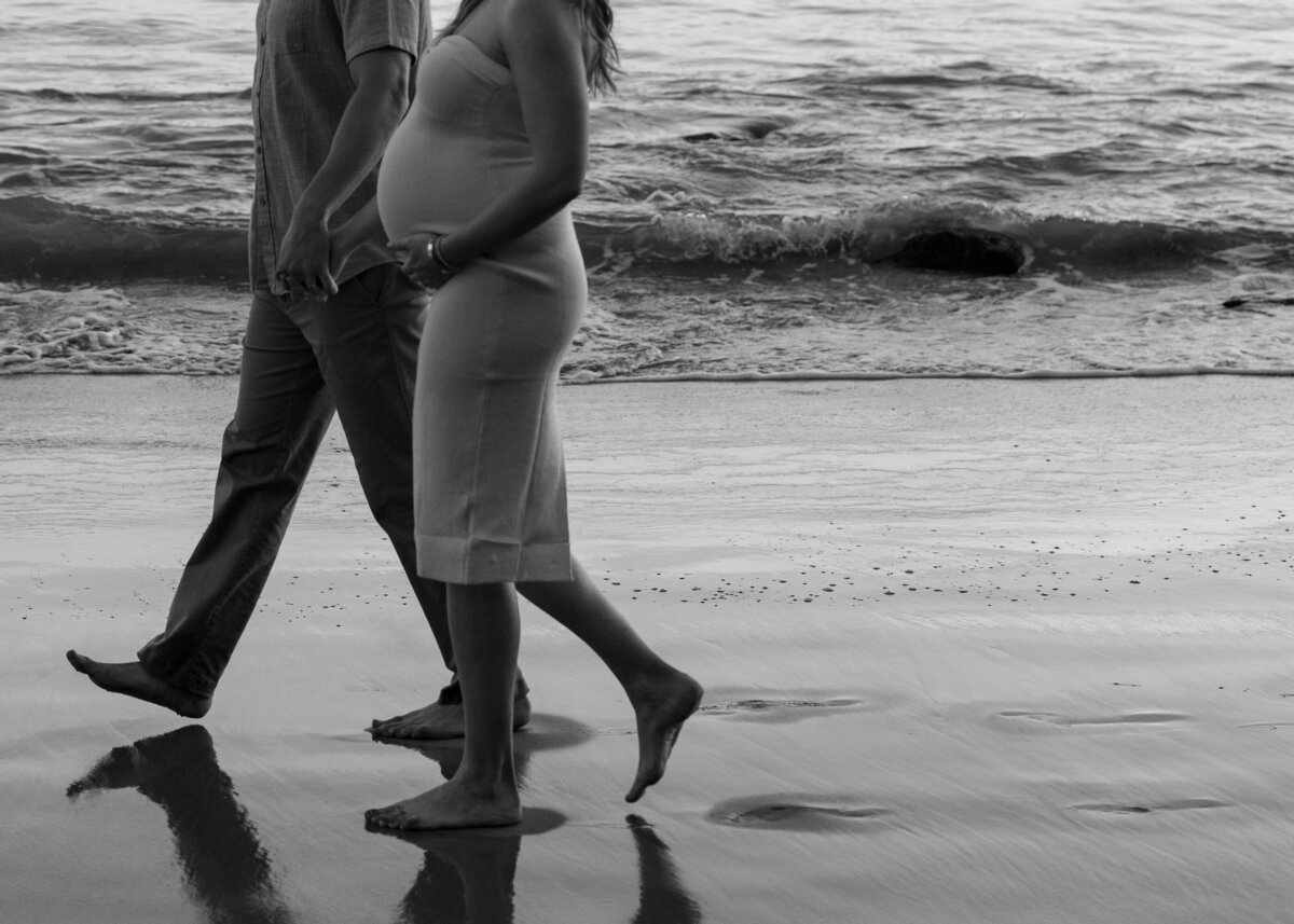 romantic and moody black and white maternity photo at the beach