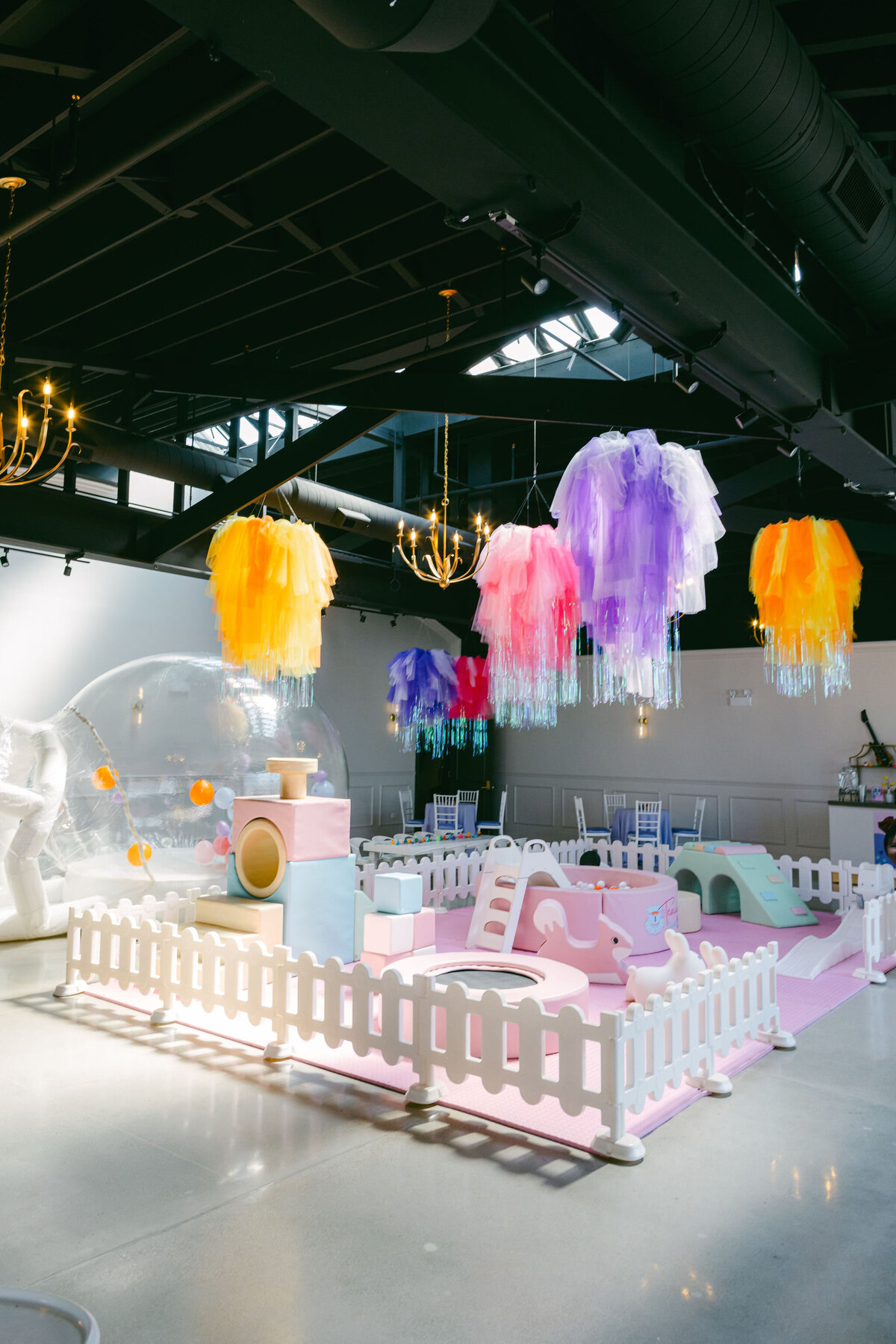 Colorful bounce house at a children’s birthday party venue, surrounded by vibrant balloons, playful decorations, and festive table settings, creating a fun and lively atmosphere
