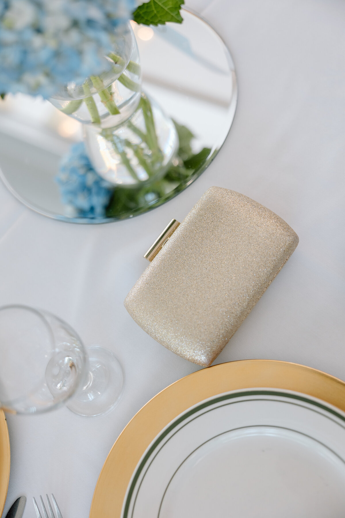 Gold purse sits on table during cocktail hour