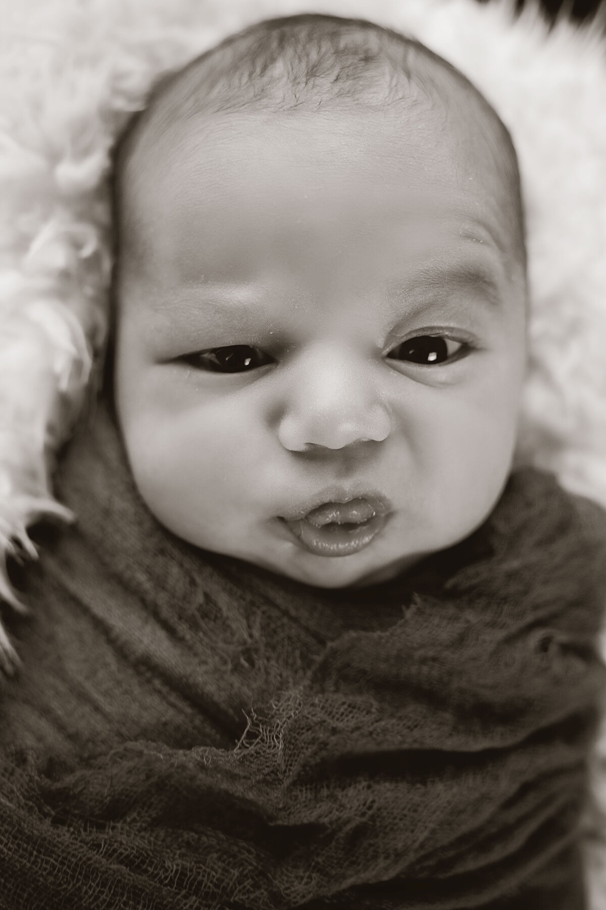 cute newborn sticking tounge out