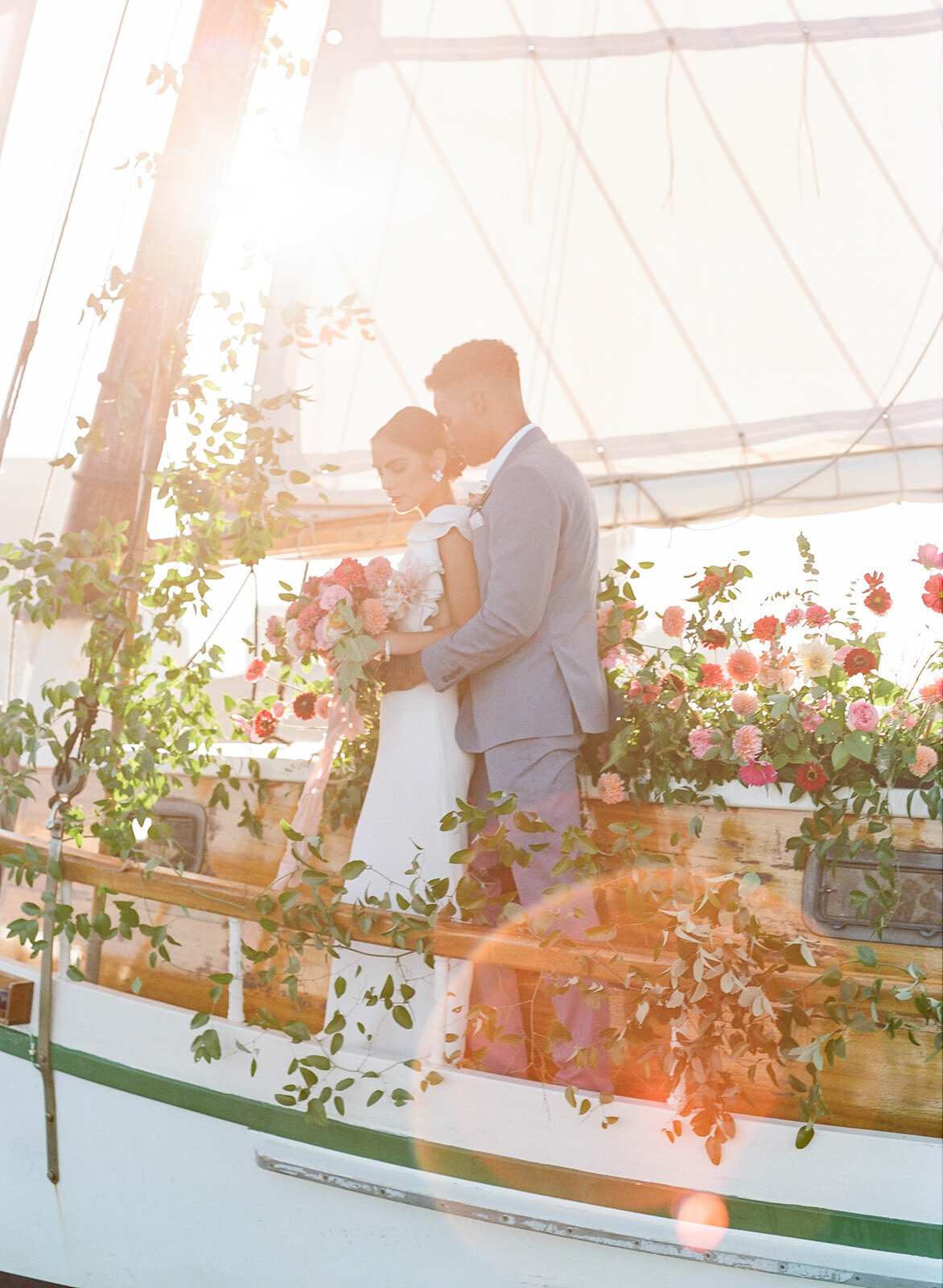 Kate-Murtaugh-Events-elopement-wedding-planner-Boston-Harbor-sailing-sail-boat-yacht-greenery-floral-installation-golden-hour-sunset-couple