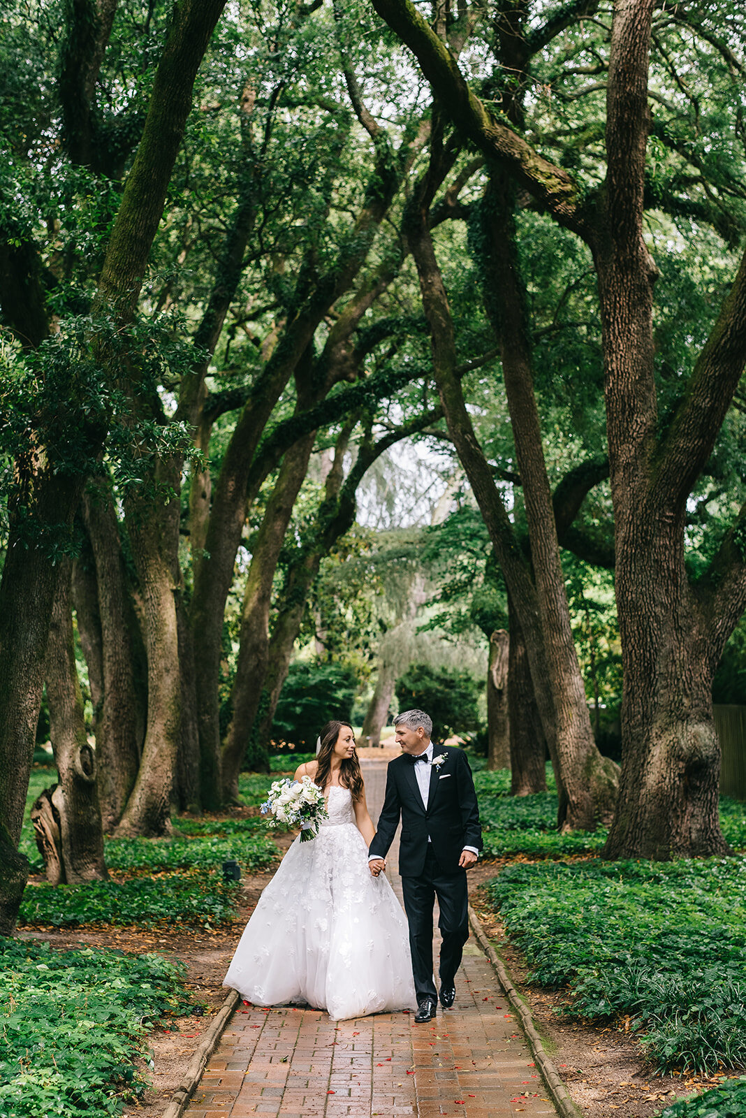 Bride and groom with white and blue bouquet designed by Abby Grace Florals at Greenville SC wedding