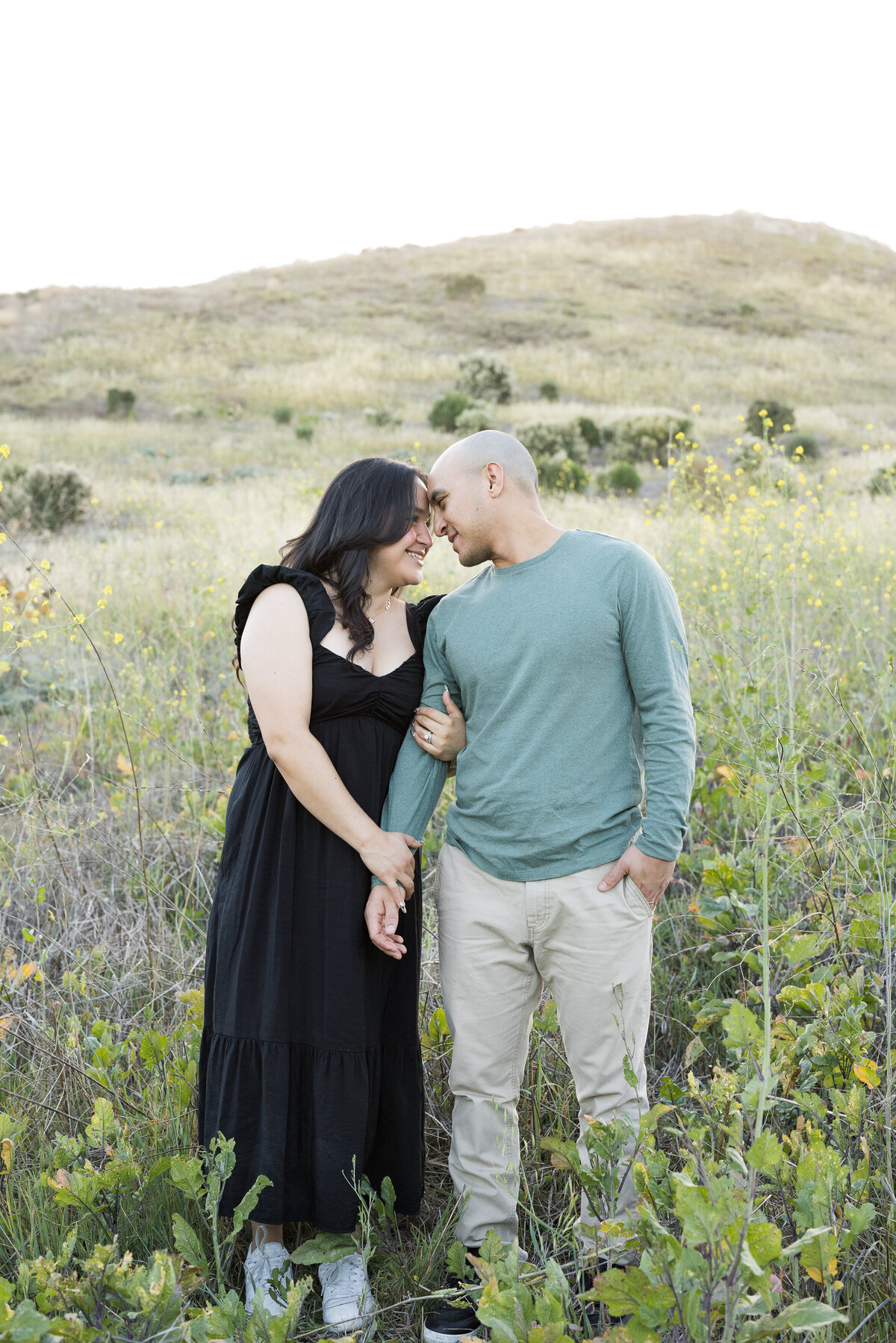 candid engagement photo in open field
