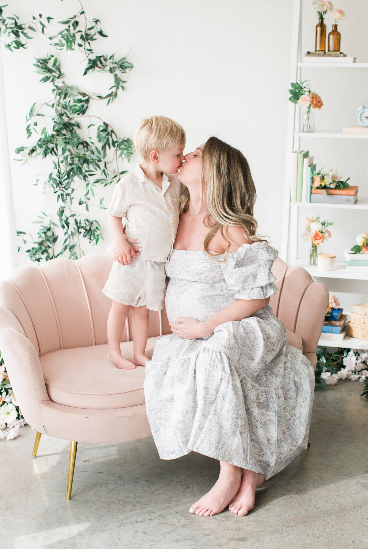 A pregnant mom with her toddler during a studio maternity session in Denver