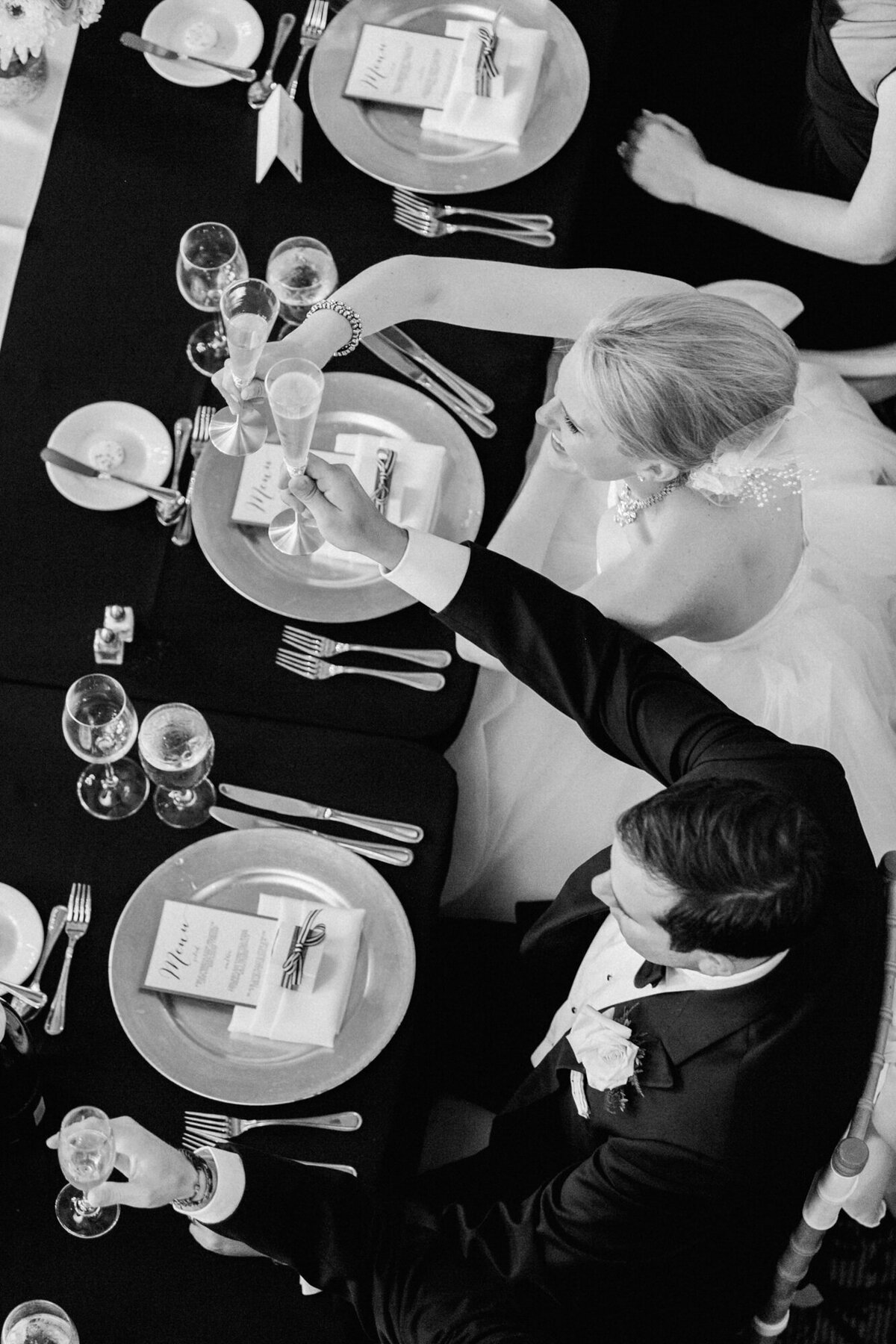 A photograph taken from above as newlyweds toast to their marriage